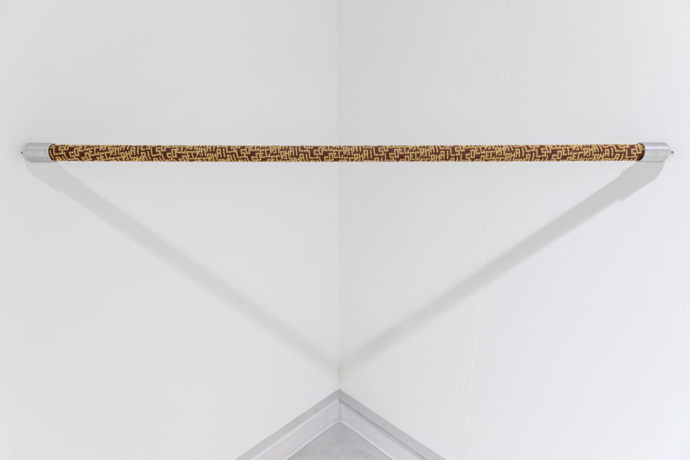 Installation view by Aldo Grazzi, Singolare - Plurale, 2014, Hurdles in glass beads, 100 x 3 cm